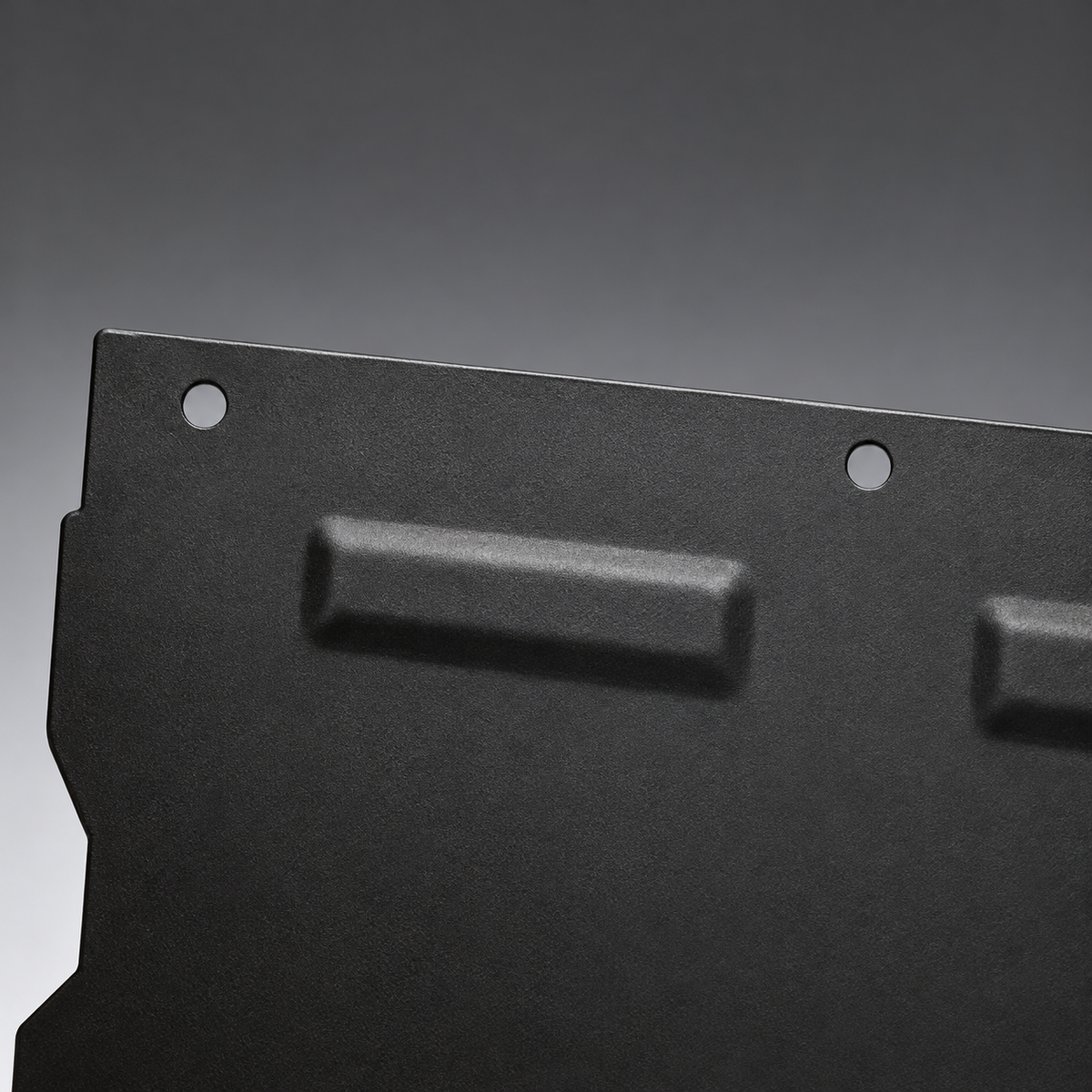 Round mounting holes along the upper edge of the steel motor guard