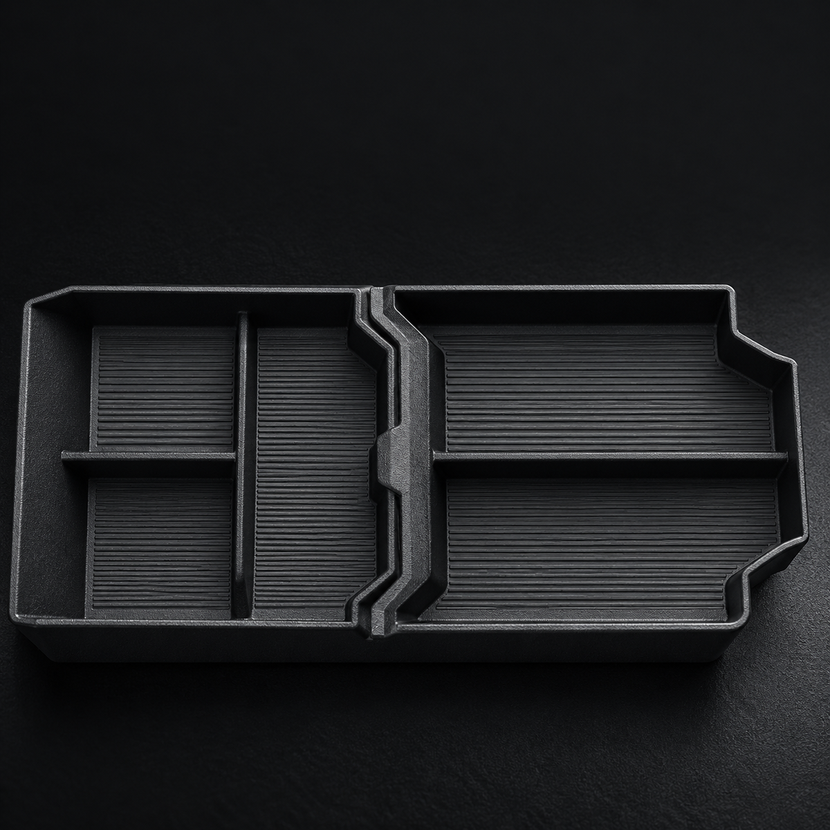 Open compartments in the normal Cybertruck lower-console organizer; text-free detail image