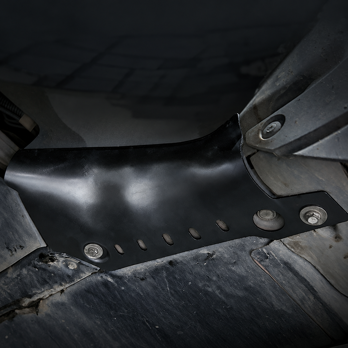 Black coolant-pipe guard shown in the supplier-photographed underbody installation area.