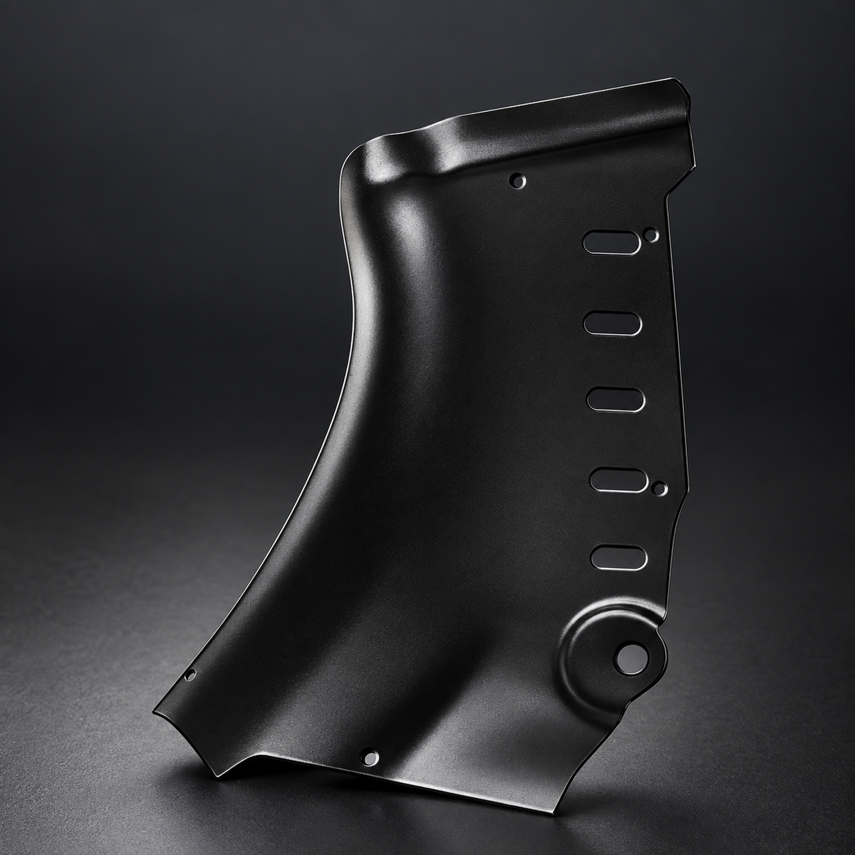 Single refreshed Model 3 guard half showing the formed carbon-steel shape, edge and openings.