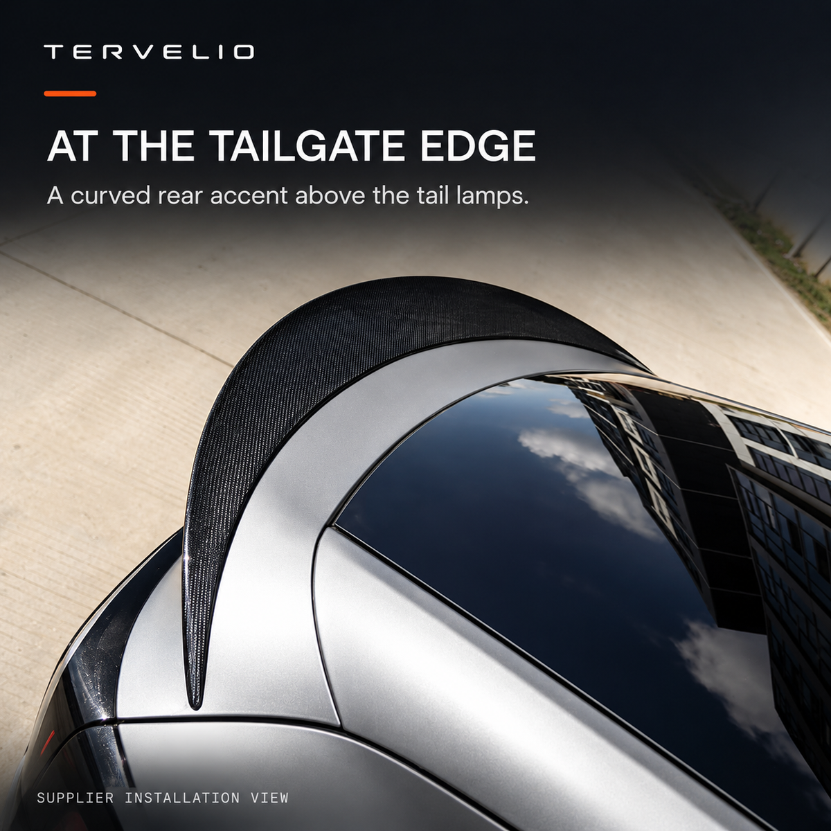 Top-down supplier installation view of the curved spoiler on the upper tailgate edge.