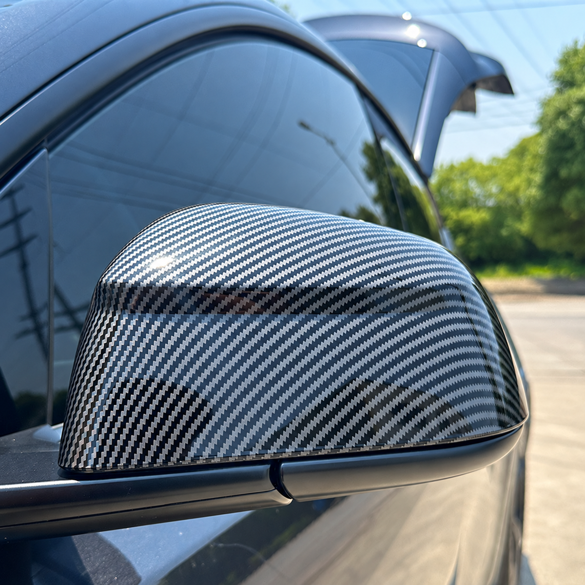 TERVELIO carbon-style mirror cover shown fitted to the supplier's Model Y mirror housing; vehicle generation and housing shape must match the selected configuration.