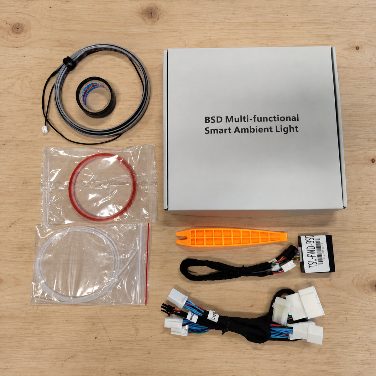 Unpowered ambient light kit components and packaging on a wooden workbench