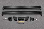 Two unassembled roof rack crossbars and their components on a grey inspection mat