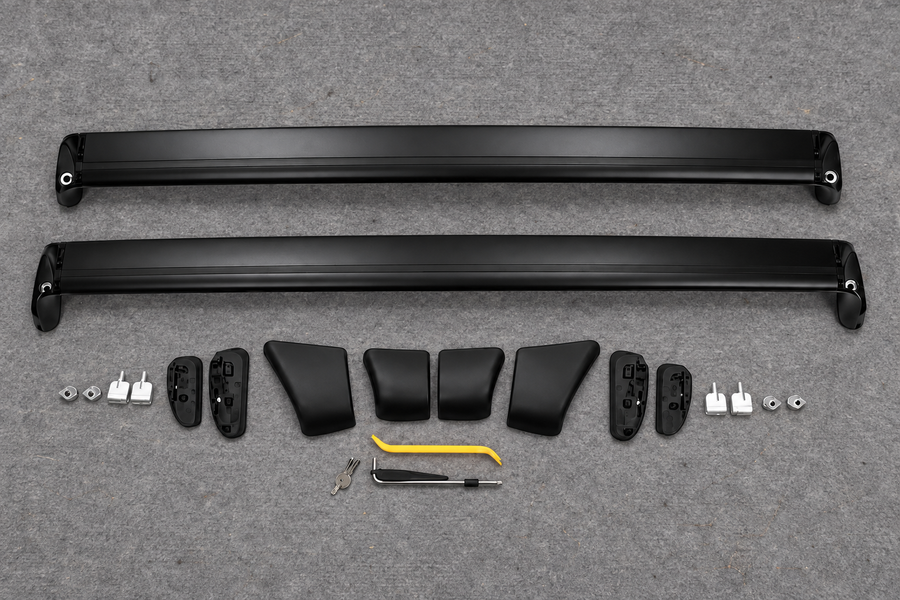 Two unassembled roof rack crossbars and their components on a grey inspection mat