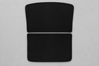 Two black split roof sunshade panels lying flat on a grey inspection surface