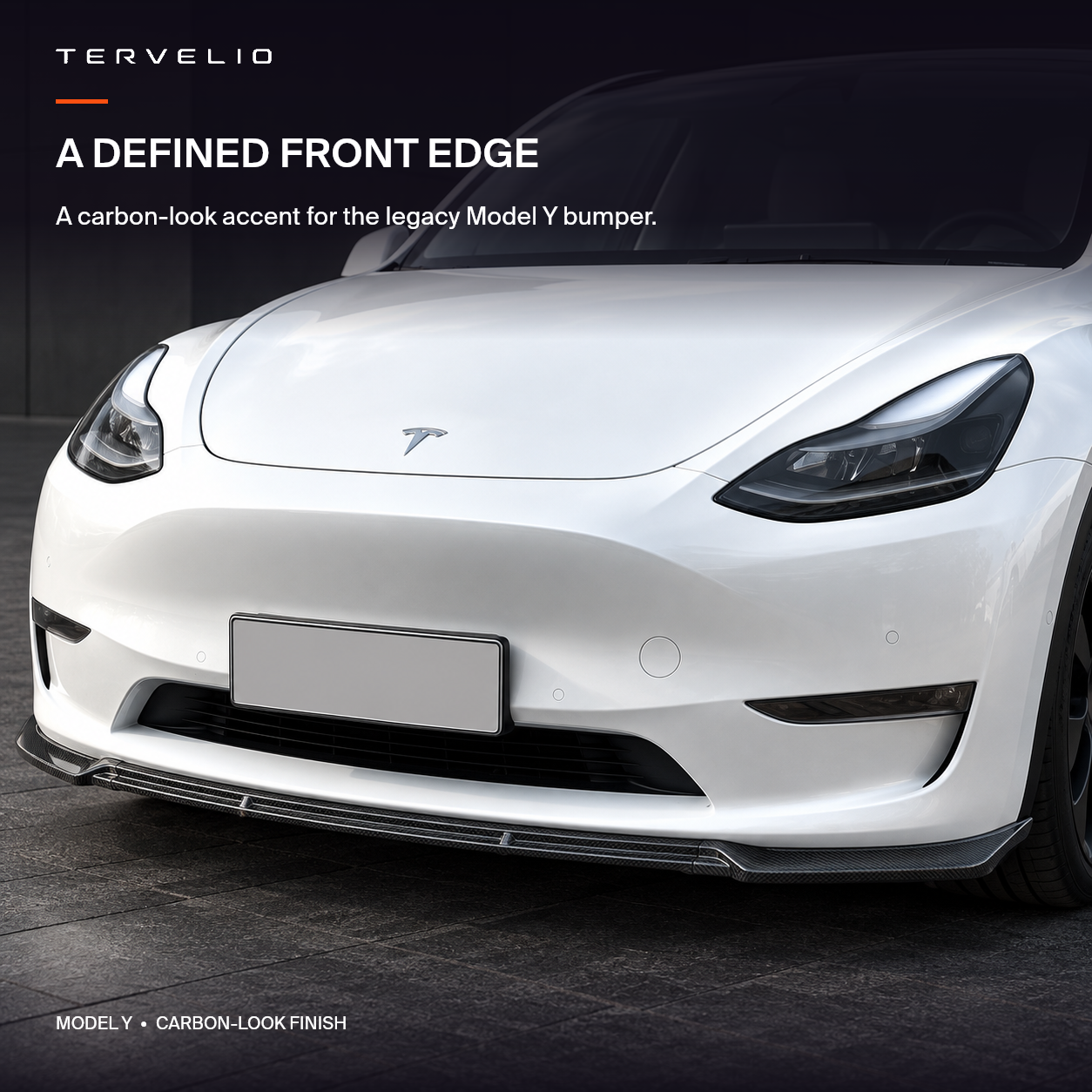 Carbon-look front lip installed along the lower bumper of a white legacy Tesla Model Y