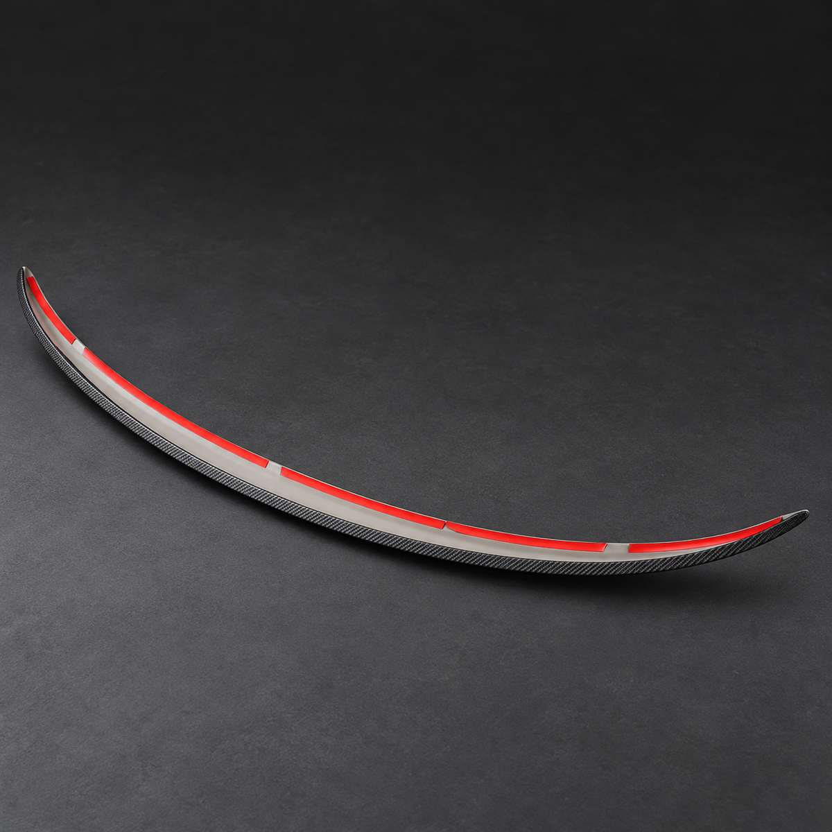 Inside mounting side of the curved rear spoiler with red adhesive release liner