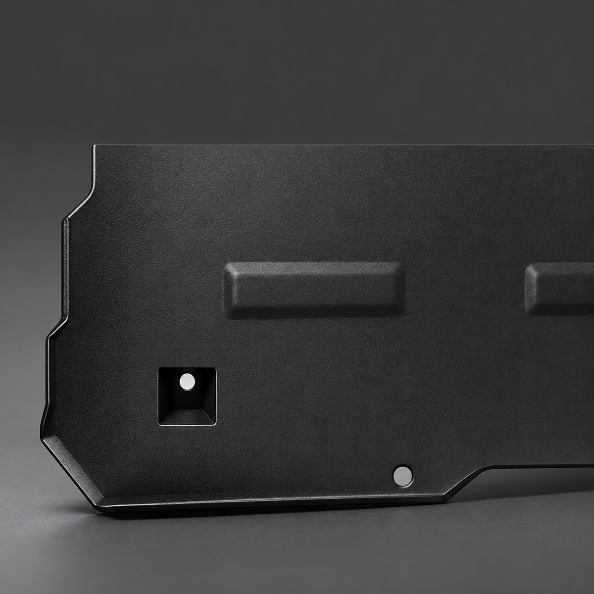 Notched lower edge and recessed mounting opening of the steel front motor guard