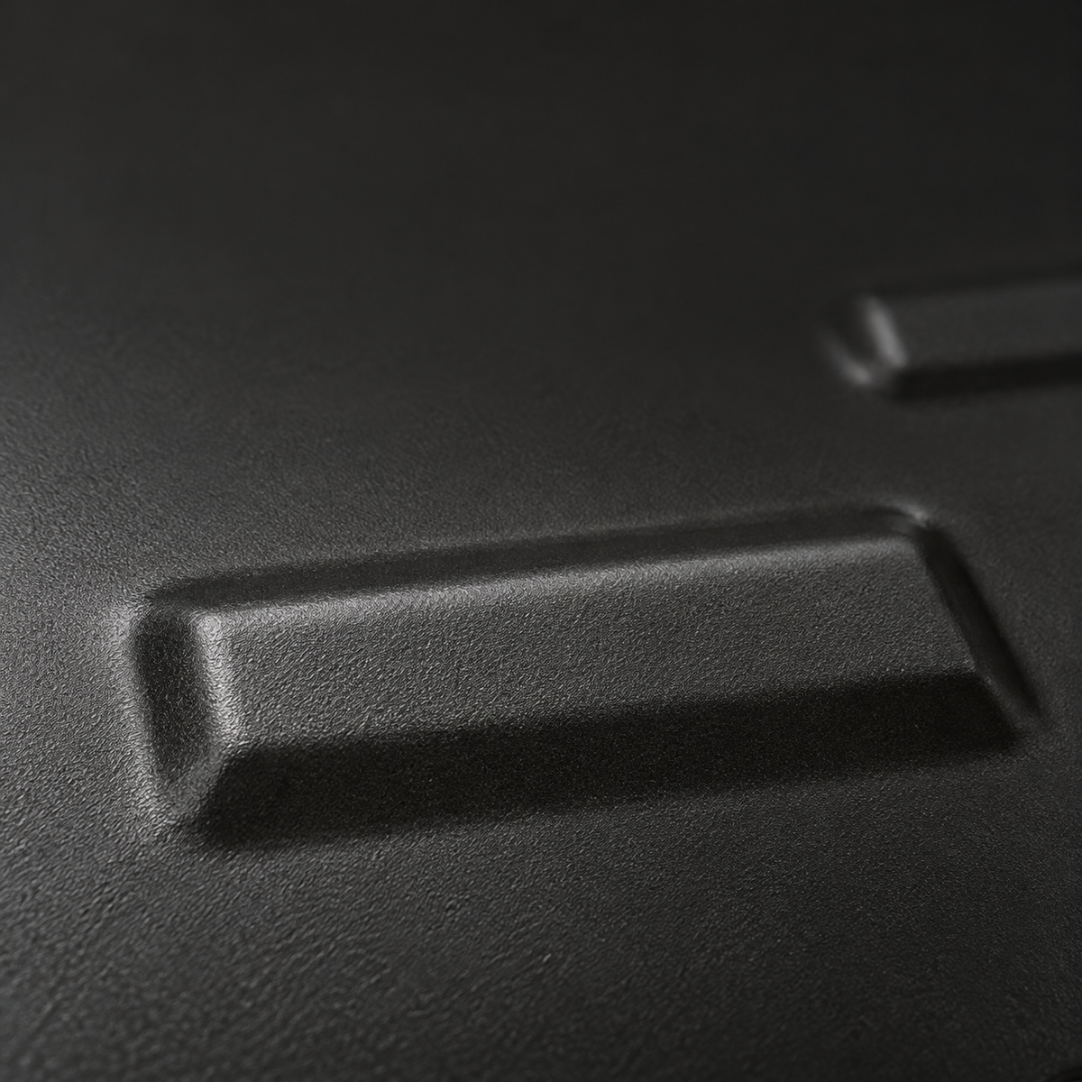 Raised stamped rib and matte-black coated steel surface of the front motor guard