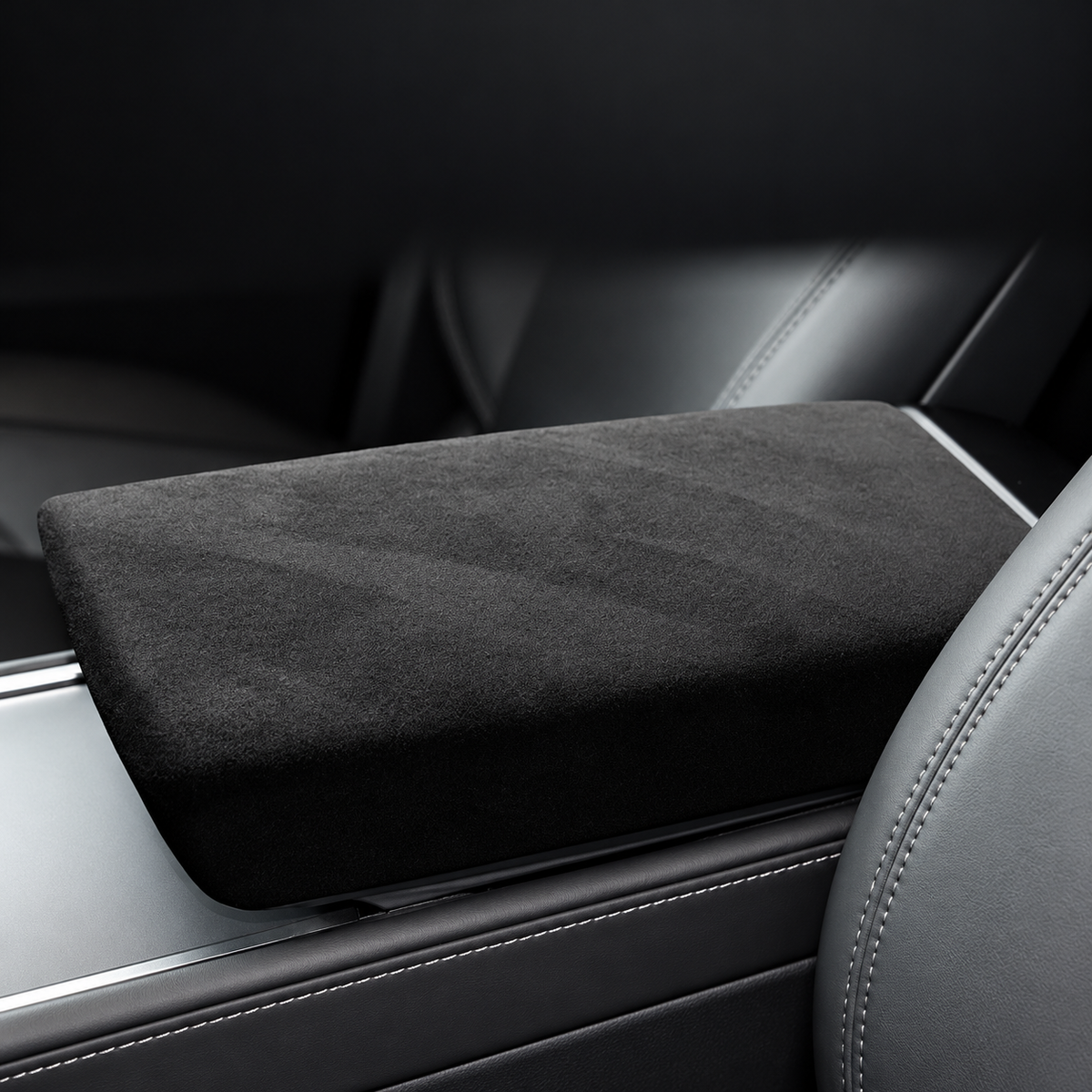 Charcoal suede-finish armrest lid cover installed in a vehicle cabin, without text overlay.