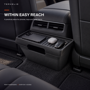Rear-seat storage box positioned behind the center console with small daily essentials organized inside.