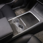 Carbon fiber center console panel cover shown installed around the cupholder area