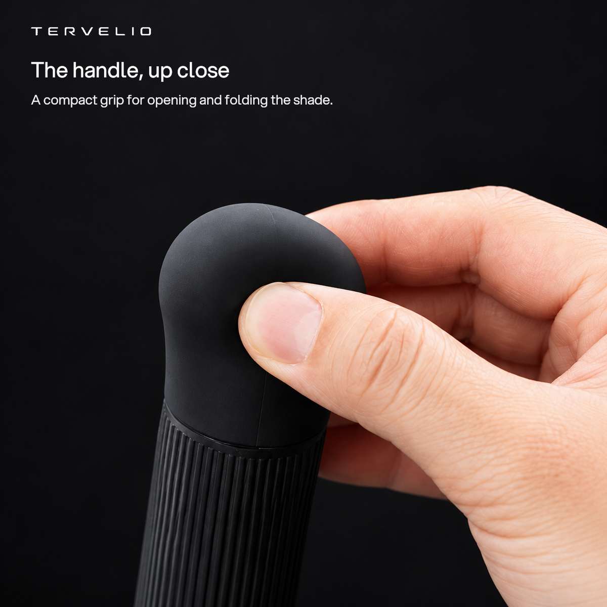 The handle, up close. A compact grip for opening and folding the shade.