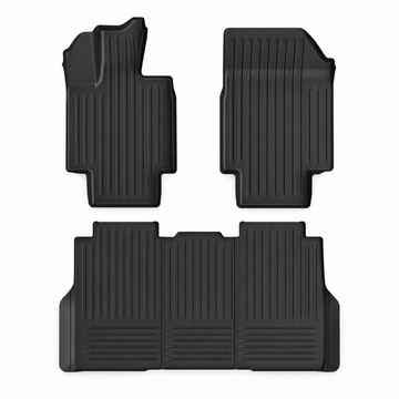 Three black Cybertruck cabin floor mats on white.