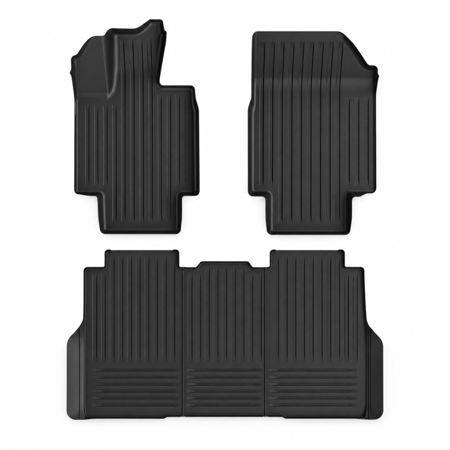 Three black Cybertruck cabin floor mats on white.
