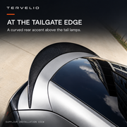 Top-down supplier installation view of the curved spoiler on the upper tailgate edge.