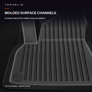 Close-up of the molded channels and raised edge of the black TPE floor mat