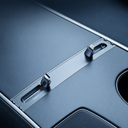 Supplier-derived close-up of the grey console hub with separate USB-C and Lightning connectors in recessed holders.